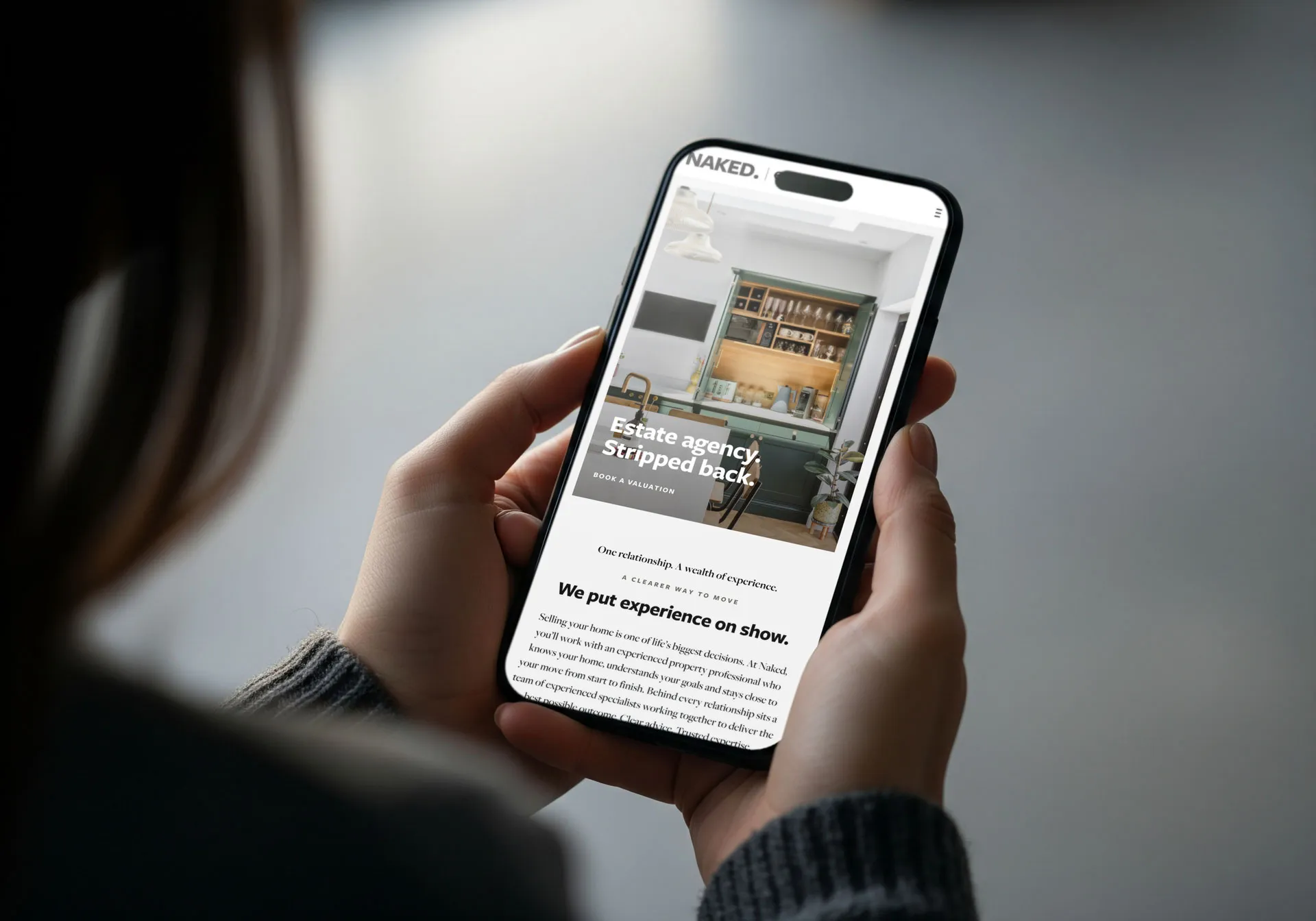 The Naked homepage shown on a mobile phone, reading Estate agency. Stripped back.