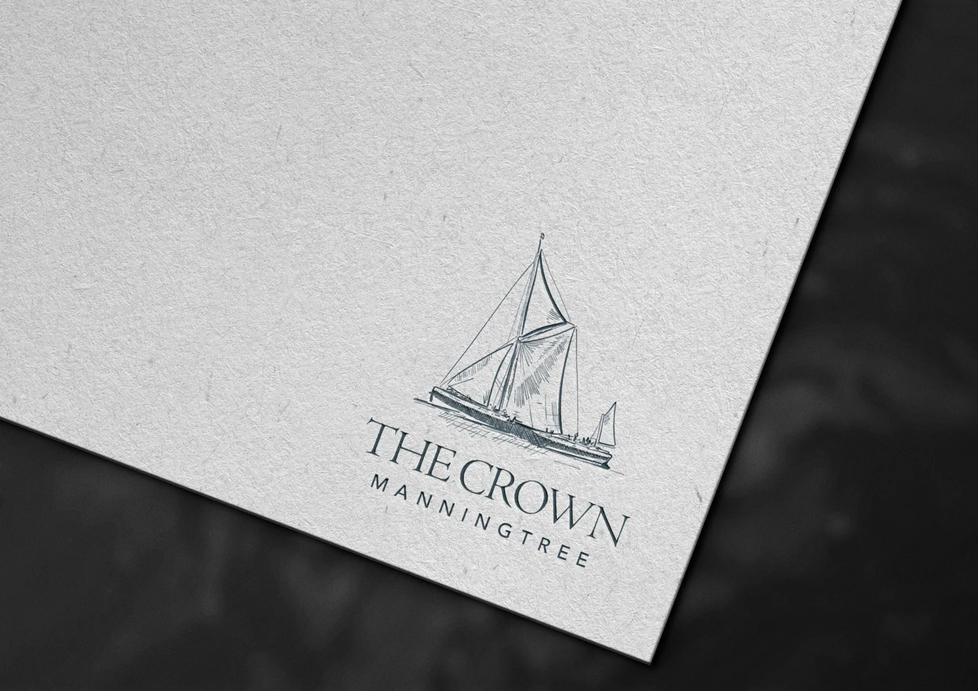 The Crown logo on a paper mockup